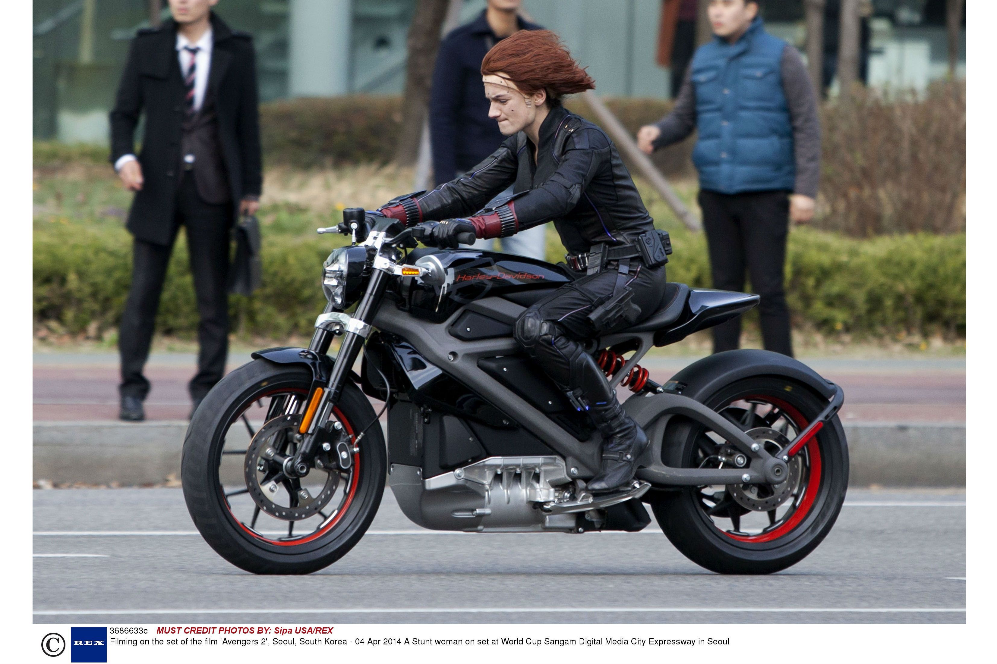 A fake Scarlett Johansson on an electric Harley on the set of the Avengers II