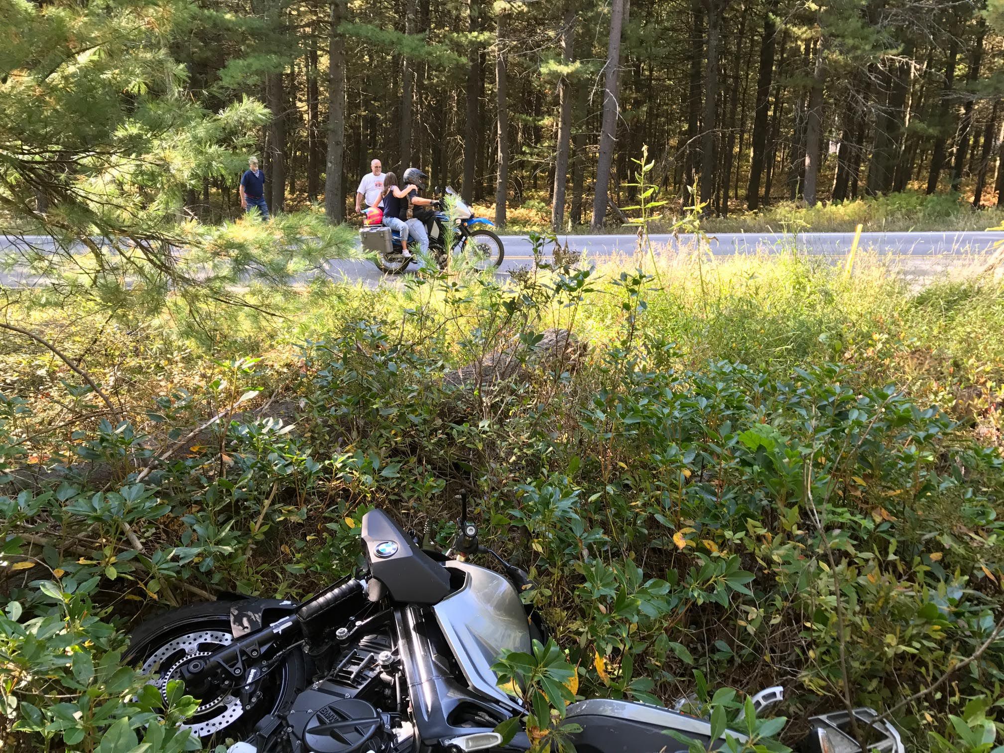 Bikers stopped to help, ironically the pilion was not wearing a helmet to "dry her hair"