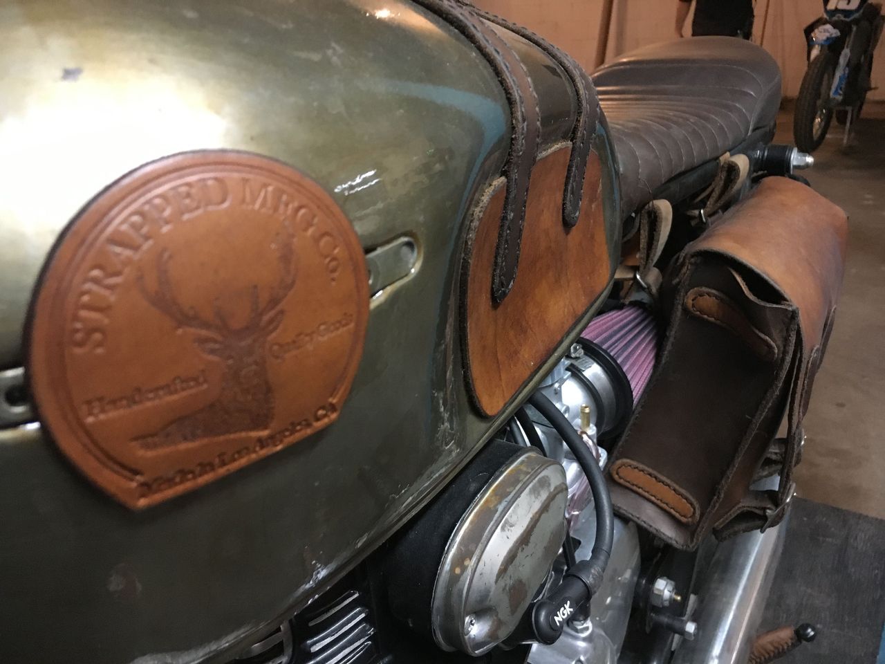 The use of leather on this custom Honda made it truly unique. The seat, grips, tank badge, knee-guards, tool bag, shift lever and even the kickstand all were made of leather or used leather accents